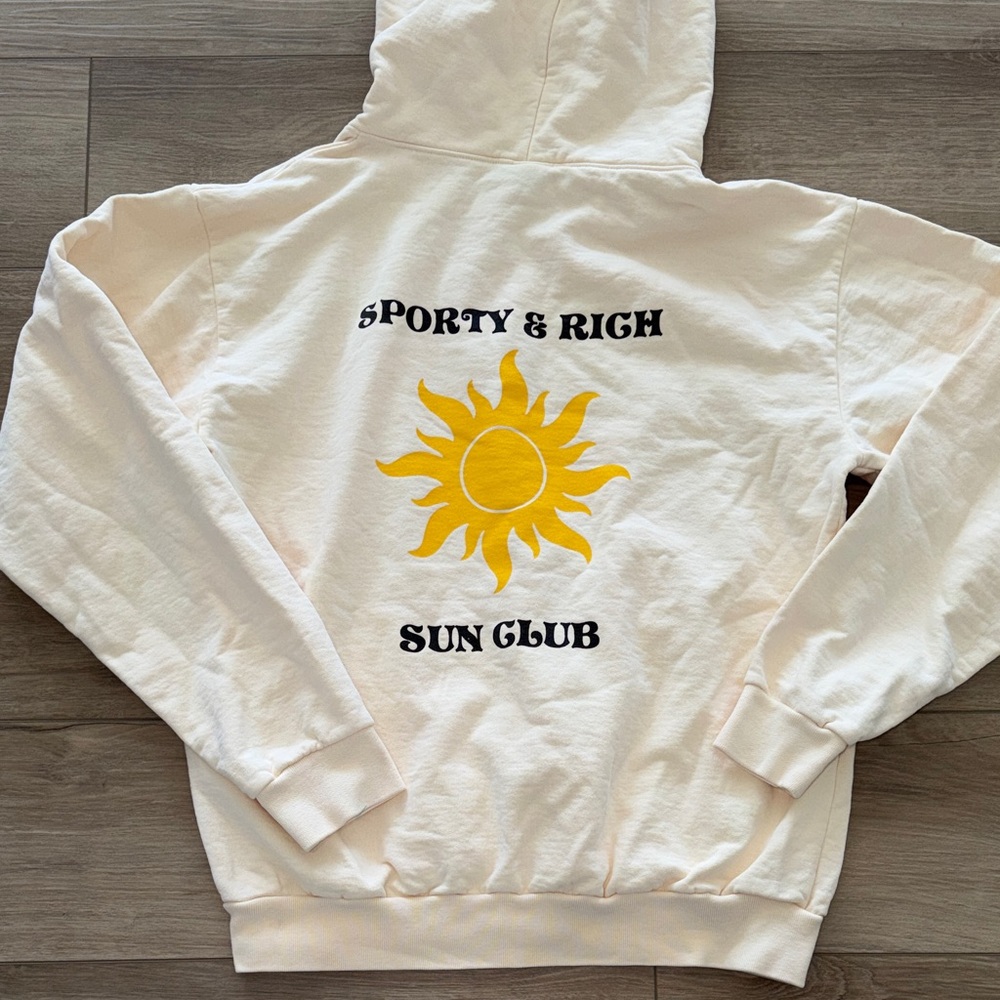 Sporty & Rich Cream Hoodie with Yellow Sun Graphic